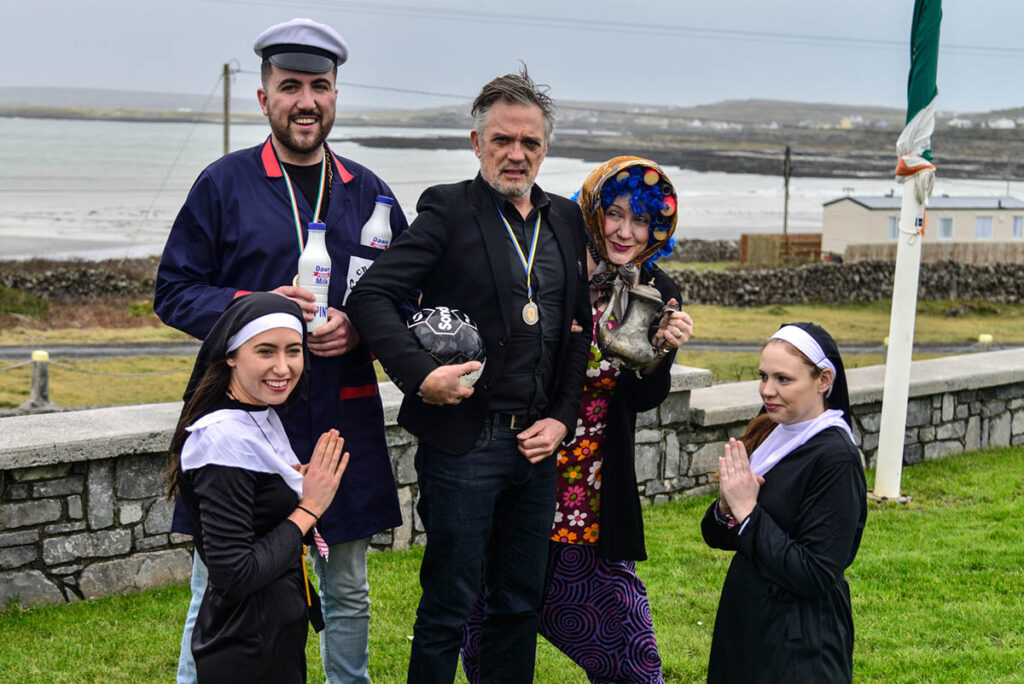 Joe Rooney AKA Fr Damo pictured with Sr Kate Finnegan, Michael Morrin as Pat Mustard, Suzie Queripel as Mrs Doyle and Sr Eimear O Dea at TedFest on Inis Mor, Aran Islands which becomes the legendary Craggy Island every year. TedFest is back on March 2nd-5th 2023 with copious cups of tea and sandwiches, a lot of red tank-tops, nuns on the run, priests on the pull, map-cap costumes and of course a bishop getting a kick up the arse. Fr Ted, Ireland’s best loved TV Show is celebrated in the most wild and wonderful way. see www.tedfest.org Photo by Doris Gerth